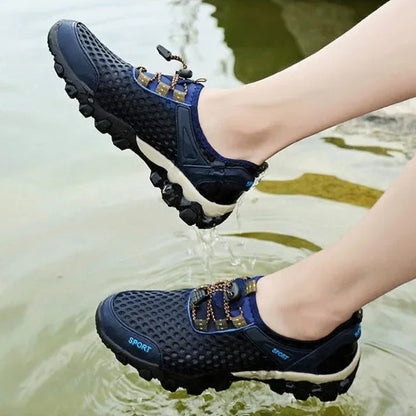 Person wearing blue water shoes stepping into water