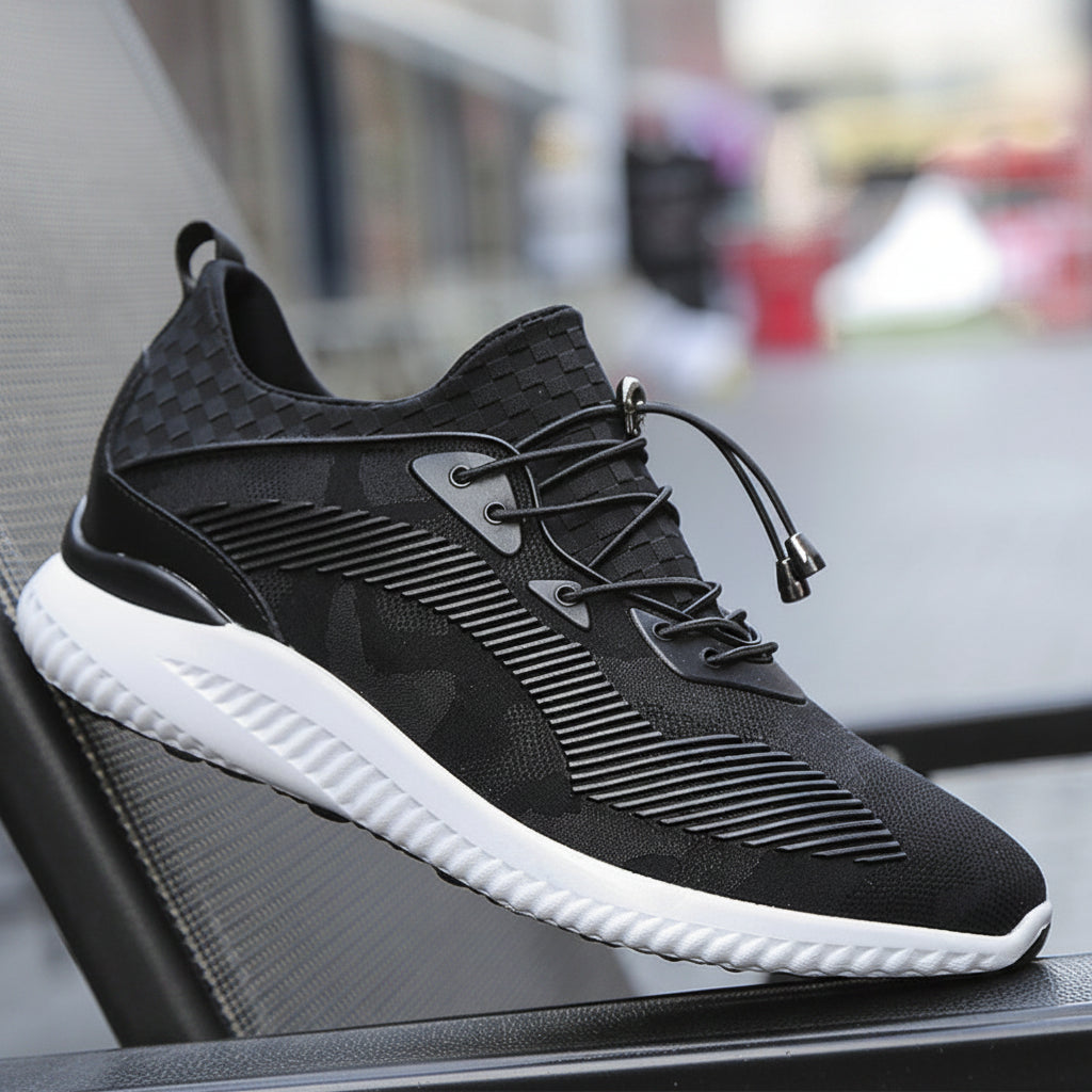 Black athletic shoe with white sole on a blurred background
