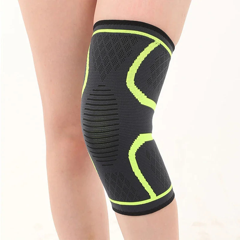 Elastic black and neon green knee support brace worn on leg for joint compression