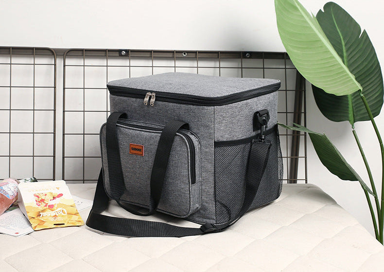Gray cooler bag on a table with a plant in the background