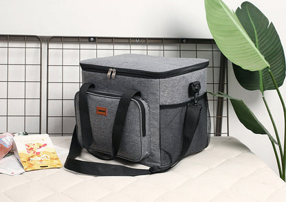 Gray cooler bag on a table with a plant in the background