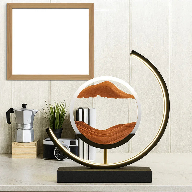Modern LED sand art lamp on a desk with plant, coffee maker, books, and blank frame