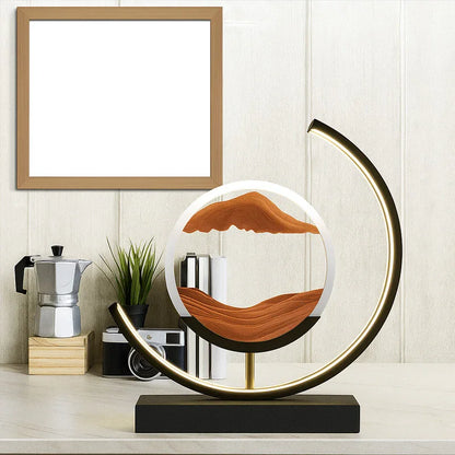 Modern LED sand art lamp on a desk with plant, coffee maker, books, and blank frame