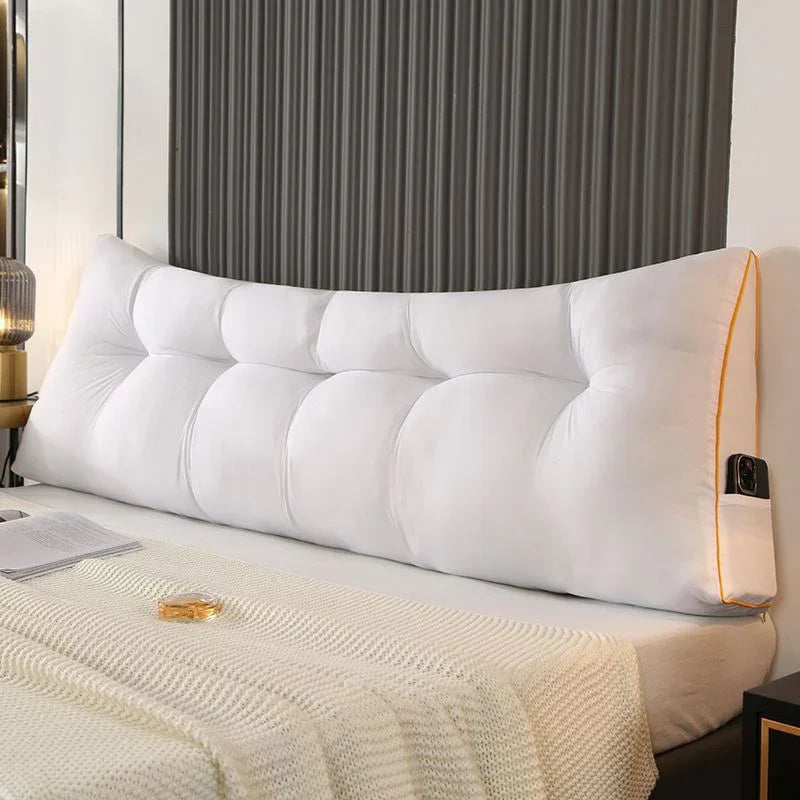 Large white tufted headboard pillow with side pocket on a bed, modern bedroom decor