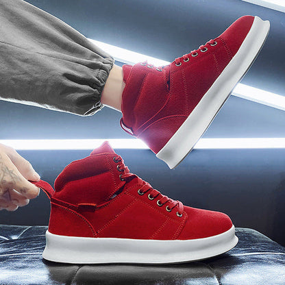 Red high-top sneakers being worn with a focus on movement and style.