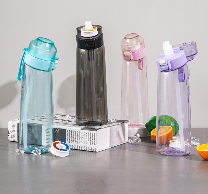 Four colorful water bottles on a table with text about vibrant colors.