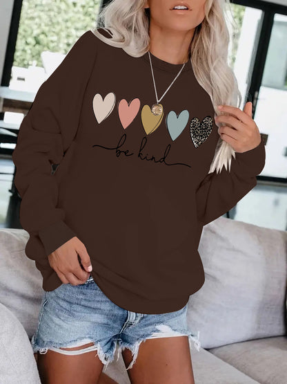 Be Kind" Multicolor Heart Print Black Sweatshirt | Cozy Women's Love Graphic Pullover