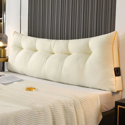 Large beige tufted backrest pillow with button accents on a bed, cozy modern bedroom decor