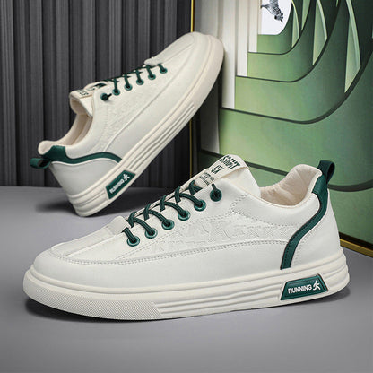 White sneakers with green accents on a gray surface