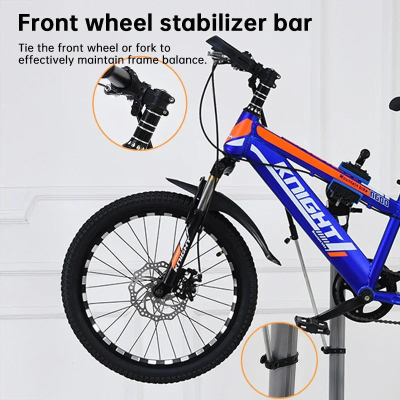 Mountain bike with front wheel stabilizer bar, black and blue frame, close-up details shown.