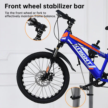 Mountain bike with front wheel stabilizer bar, black and blue frame, close-up details shown.