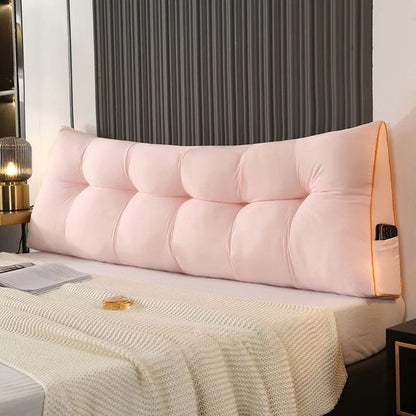 Soft pink headboard pillow with button tufting on a modern bed, cozy bedroom decor