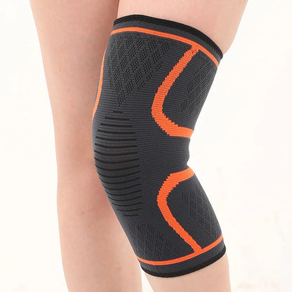 Black and orange knee compression sleeve worn on leg for joint support