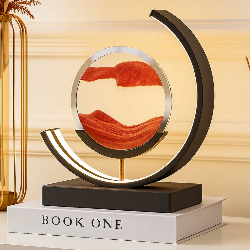 Modern round LED sand art lamp with orange sand on a book, home decor accent