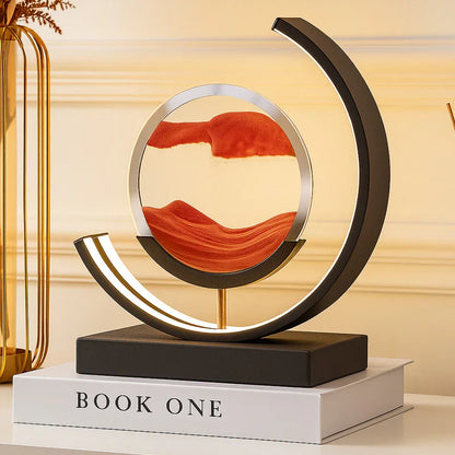 Modern round LED sand art lamp with orange sand on a book, home decor accent