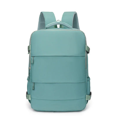 Minimalist teal backpack with padded straps, front zipper pocket, and modern design