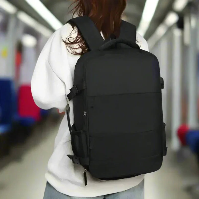 Person wearing a large black backpack on public transit, travel bag fashion