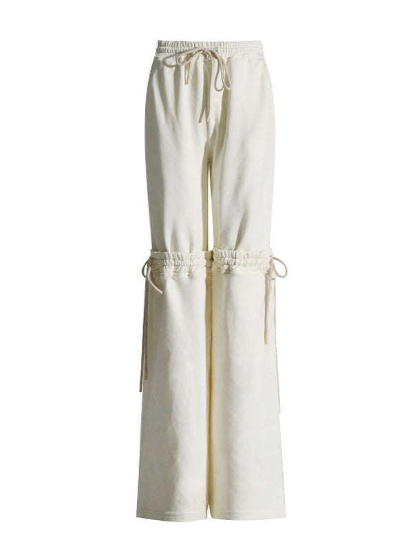 White wide-leg pants with drawstring waist on a white background