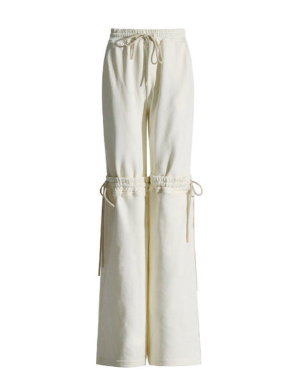 White wide-leg pants with drawstring waist on a white background