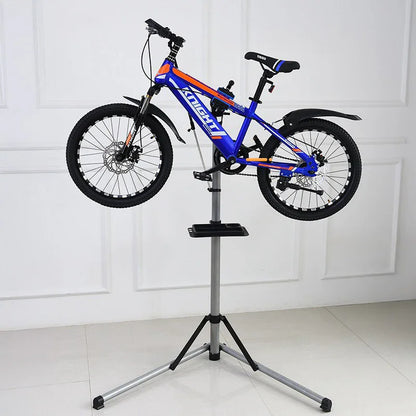 Blue and orange mountain bike mounted on a repair stand in a white indoor room