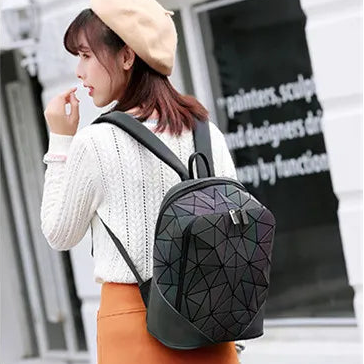 Woman wearing a geometric patterned backpack in an urban setting