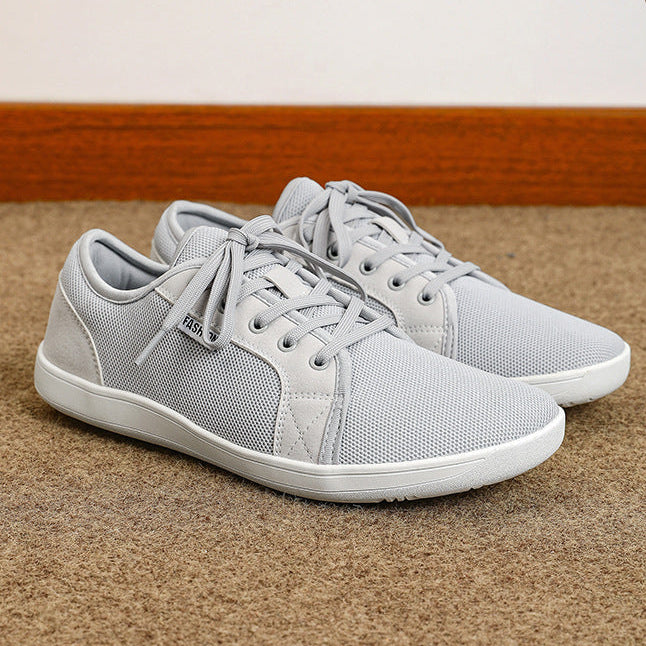Gray sneakers on a brown surface with 'COMFORT' branding above.