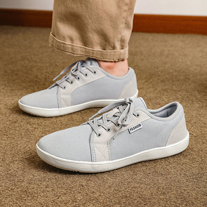 Two people wearing different shoes on a plain background with 'New Portfolio' text.