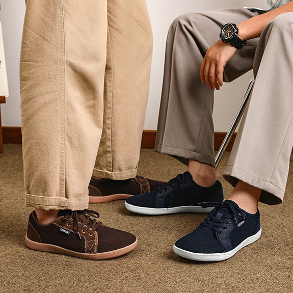 Two people wearing different shoes on a plain background with 'New Portfolio' text.